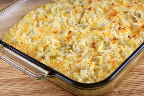 Golden baked hashbrown casserole in a glass dish