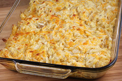 Golden baked hashbrown casserole in a glass dish
