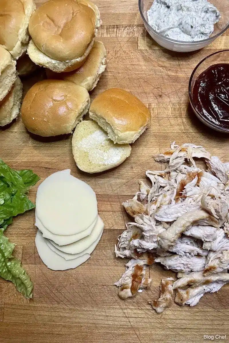 Ingredients for BBQ chicken sliders on a cutting board. 