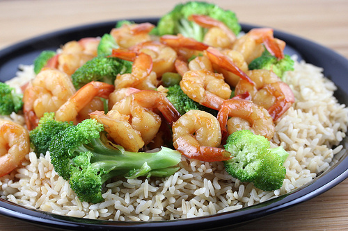 Plate of shrimp and broccoli over rice