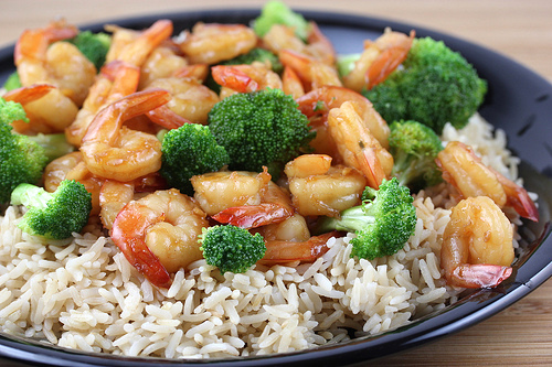 Plate of shrimp and broccoli over rice