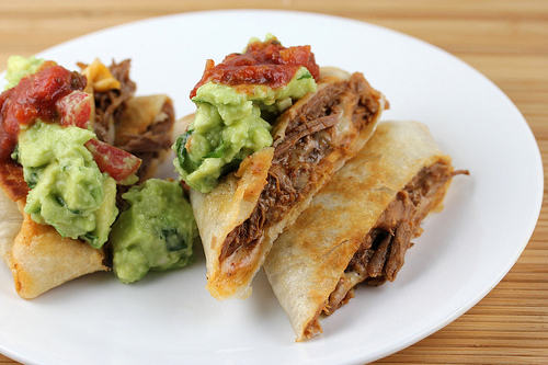 prepared beef chimichanga with guacamole and salsa