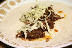 Meat and cheese for chimichanga on flour tortilla