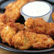 Plate of crispy ranch chicken strips served with dipping sauce