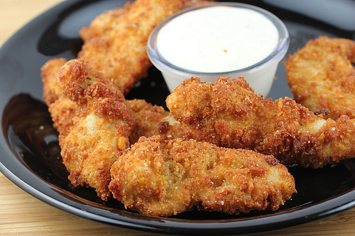 Plate of crispy ranch chicken strips served with dipping sauce