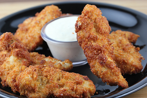 Plate of crispy ranch chicken strips served with dipping sauce