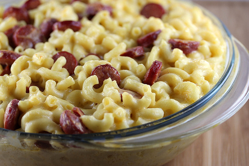 Bowl of creamy mac and cheese with sliced hot dogs