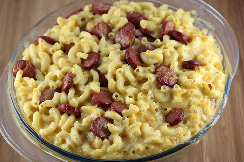Bowl of creamy mac and cheese with sliced hot dogs