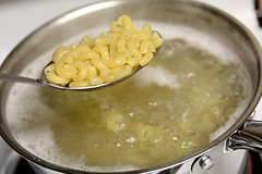 Elbow macaroni boiling in pot of water
