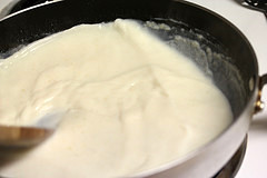Sauce being prepared in skillet for mac and cheese