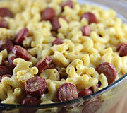 Bowl of creamy mac and cheese with sliced hot dogs