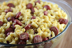 Bowl of creamy mac and cheese with sliced hot dogs