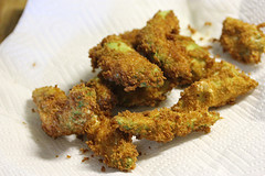 Fried avocado pieces draining on a paper towel
