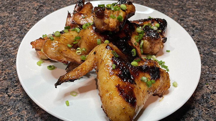 Close-up view of prepared honey mustard chicken wings.