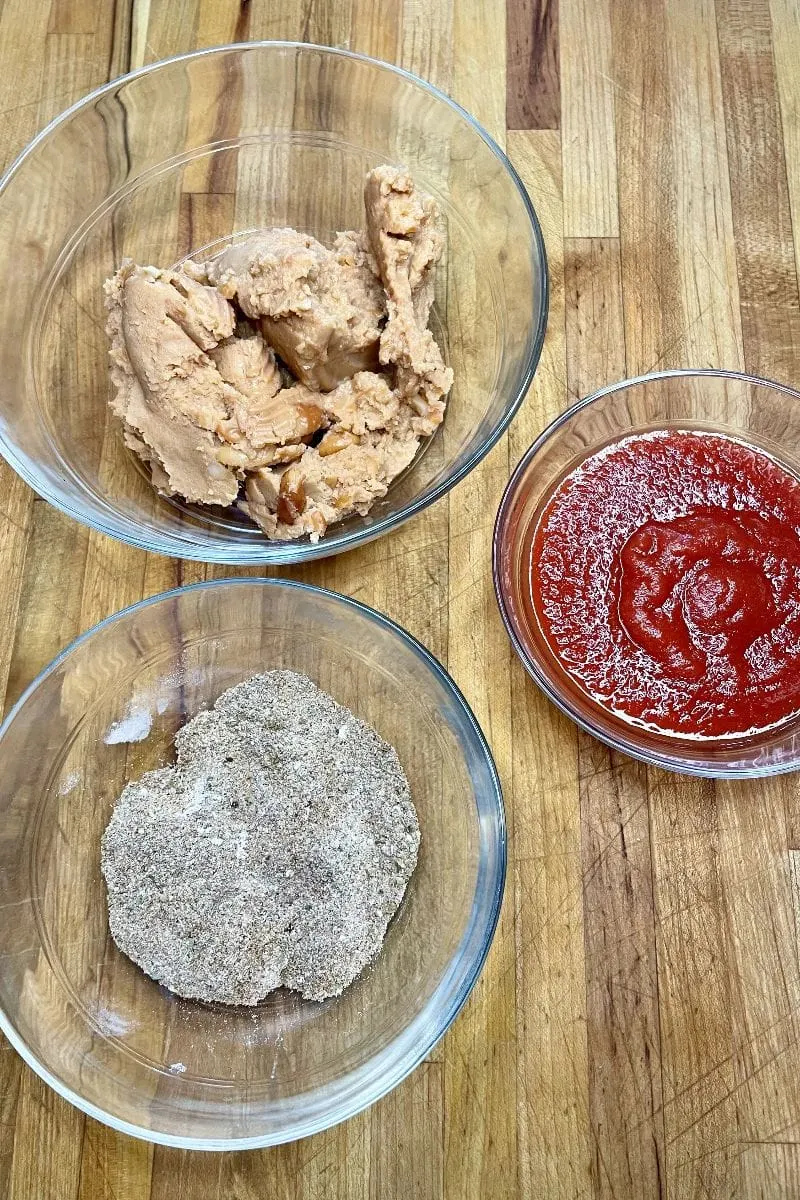 Refried beans, tomato sauce, and homemade taco seasoning for baked tacos. 