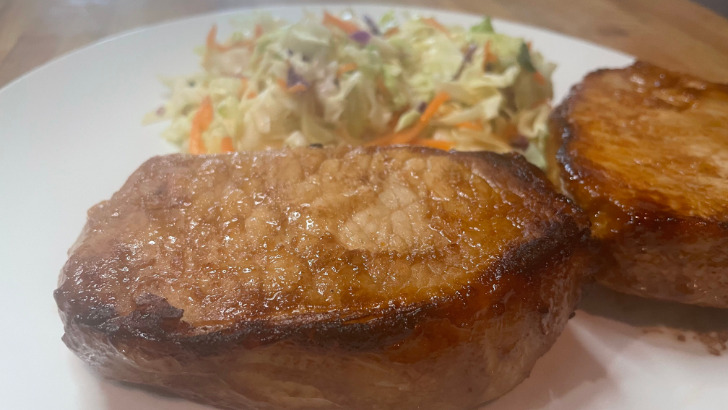 Prepared teriyaki pork loin chops on plate.