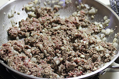 Ground beef cooking in a pan for taco tater tot casserole