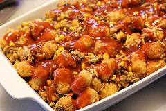 Taco tater tot bake with ground beef, tomatoes, and melted cheese