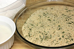Bowl of seasoned breadcrumbs with flour and egg wash for coating cheese bites