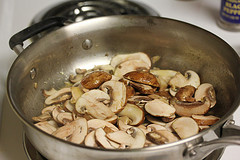 Sliced mushrooms cooking in a skillet
