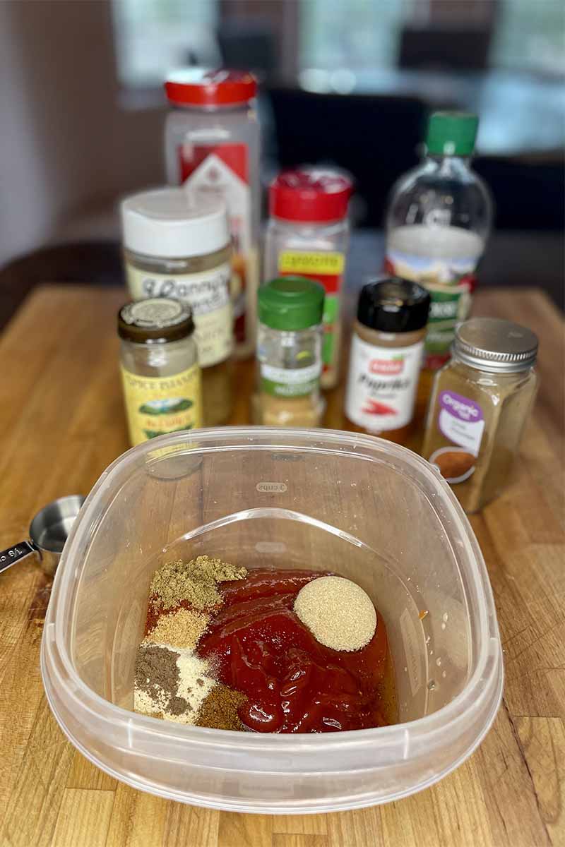 Ingredients for slow cooker pulled chicken on cutting board.