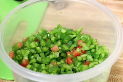 lose-up of chopped green pepper salsa in a container