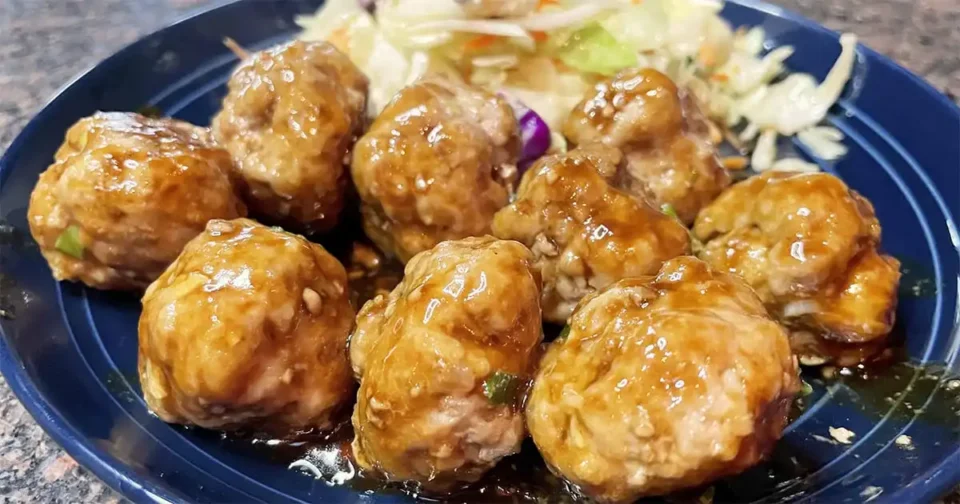 Hoisin meatballs on plate with Asian slaw.