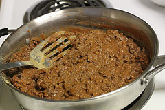 Ground beef cooking in pan for hot taco dip
