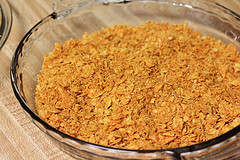 Bowl of crushed Doritos breading mix for chicken strips