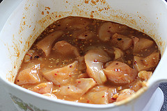 Chicken pieces marinating in a bowl