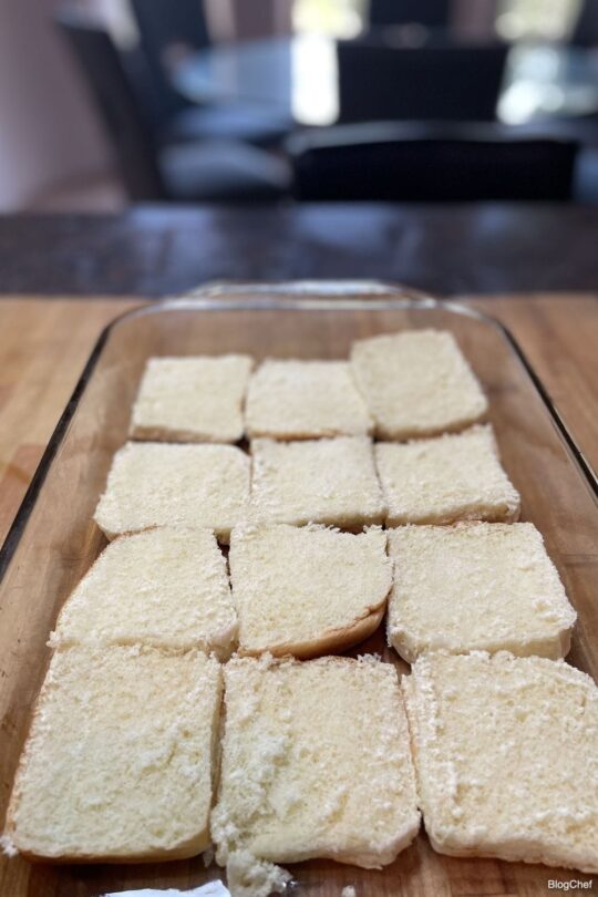 Assembling turkey and cheese sliders with poppy seed sauce.