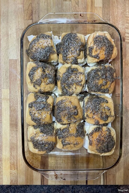 Turkey and cheese sliders with poppy seed sauce.