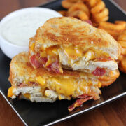 Chicken bacon ranch grilled cheese sandwich served with curly fries and ranch dressing