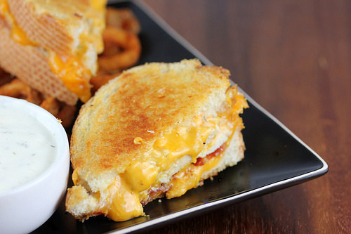 Chicken bacon ranch grilled cheese sandwich served with curly fries and ranch dressing