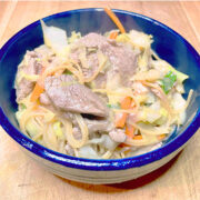 Prepared Shanghai noodles in blue bowl.