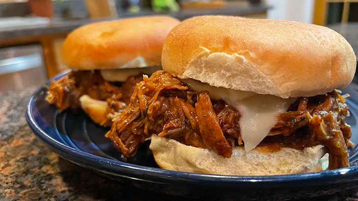 Close up of slow cooker Italian beef sliders.