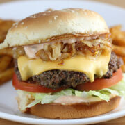 In N Out burger with lettuce tomato cheese and grilled onions served with fries