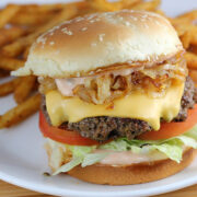 In N Out burger with lettuce tomato cheese and grilled onions served with fries