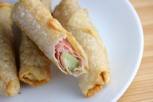 Plate of fried pickle egg rolls with ham filling