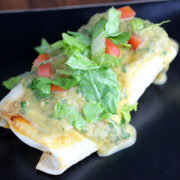 Chi Chis chimichanga topped with lettuce tomato and green sauce