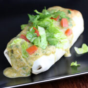 Chi Chis chimichanga topped with lettuce tomato and green sauce