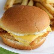 Filet o Fish sandwich with cheese and tartar sauce on a soft bun served with fries