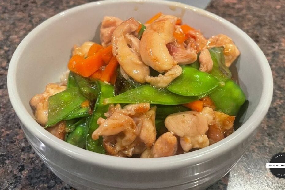 Chinese chicken with snow peas, served in a white bowl.