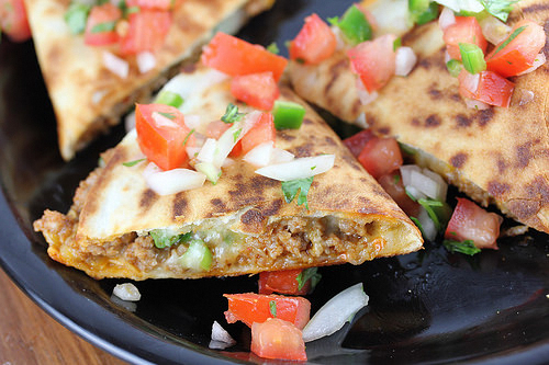 Chorizo quesadillas served on a black plate