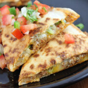 Chorizo quesadillas served on a black plate