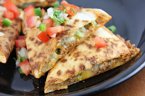 Chorizo quesadillas served on a black plate