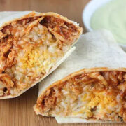 Close-up view of prepared Taco Bell chicken burrito, cut in half.