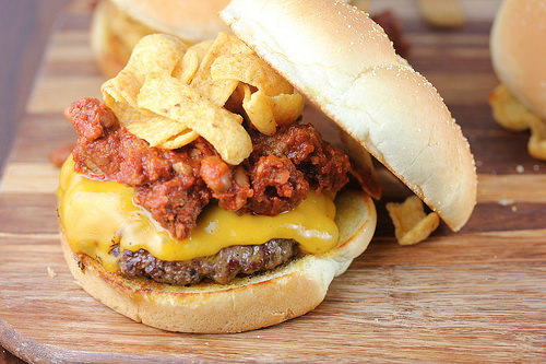 Frito cheeseburger with melted cheese and chips in a bun