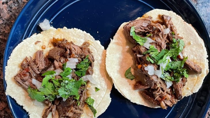 Prepared slow cooker barbacoa tacos on plate.