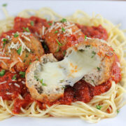 Turkey meatballs stuffed with melted mozzarella served over spaghetti with marinara sauce and shredded parmesan